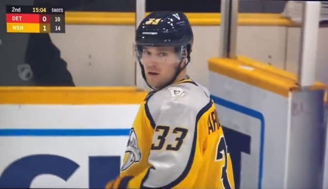 A hockey player in a yellow jersey