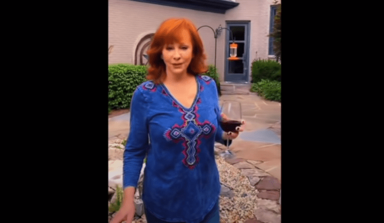 Reba McEntire holding a glass of wine
