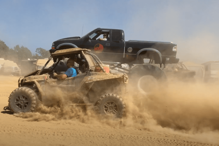 A person driving a jeep in the desert