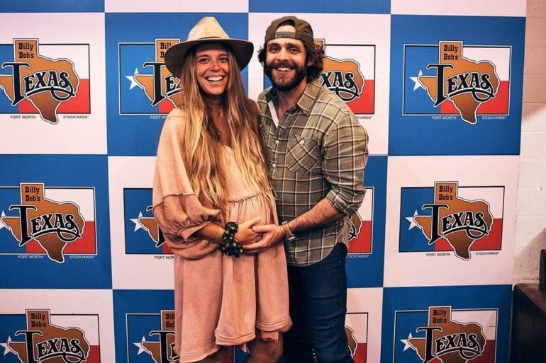Thomas Rhett and woman posing for a picture