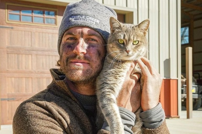 A man holding a cat