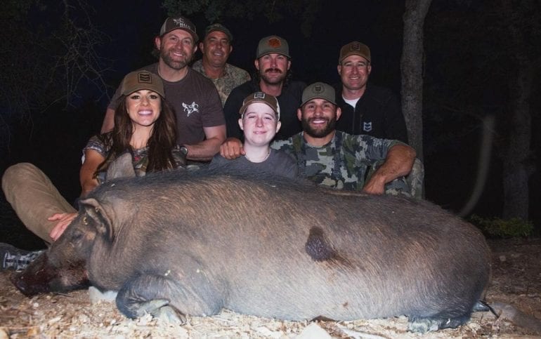 Chad Mendes et al. posing for a photo with an animal