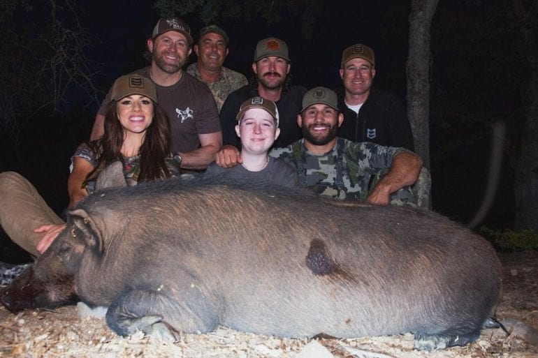 Chad Mendes et al. posing for a photo with an animal