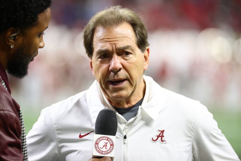 Nick Saban speaking into a microphone