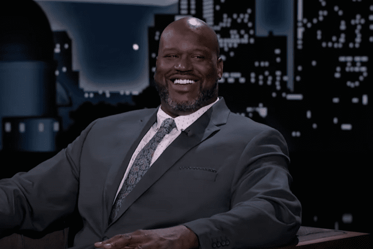 Shaquille O'Neal smiling and wearing a suit