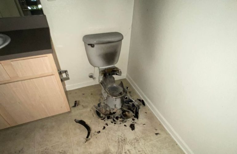 A dirty bathroom with a toilet