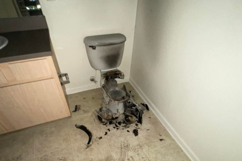 A dirty bathroom with a toilet