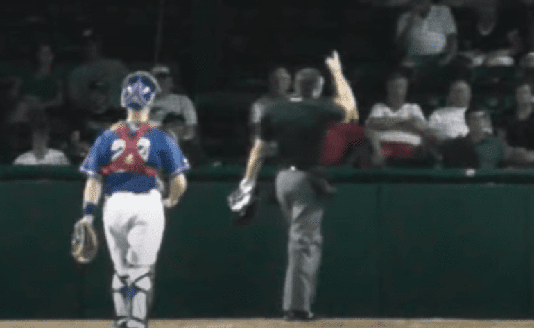 A baseball player running to home plate