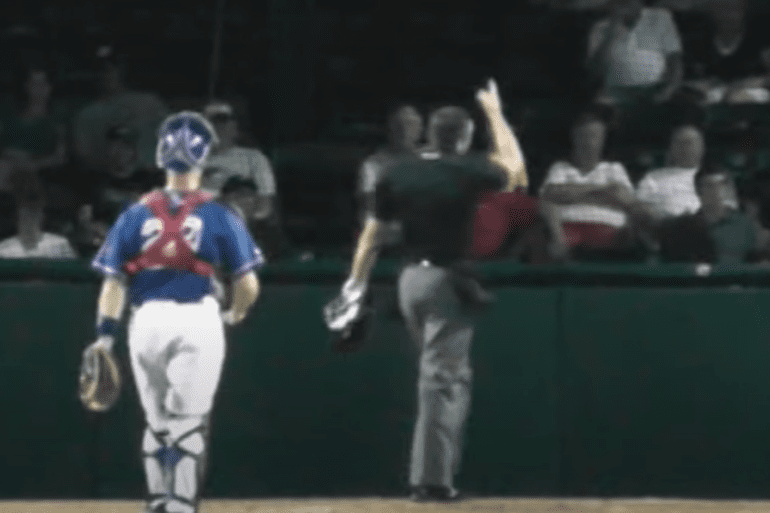 A baseball player running to home plate, umpire ejection