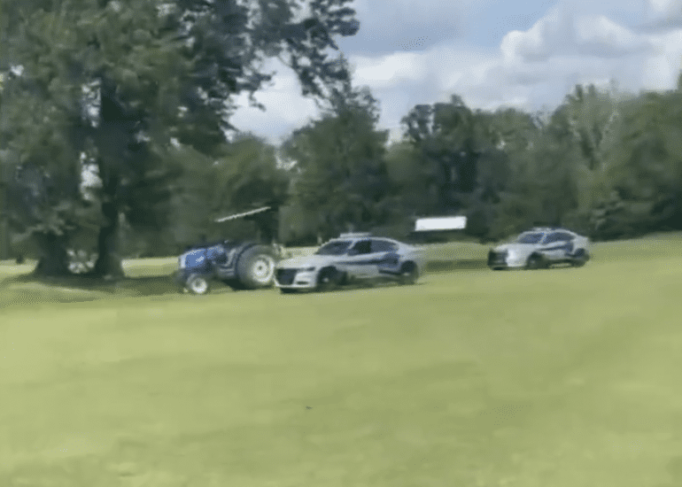A group of cars parked on a golf course