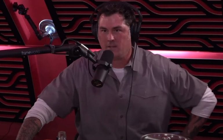 Marcus Luttrell sitting in a chair with a microphone in front of him
