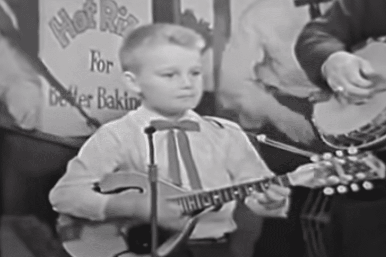 A boy playing a guitar