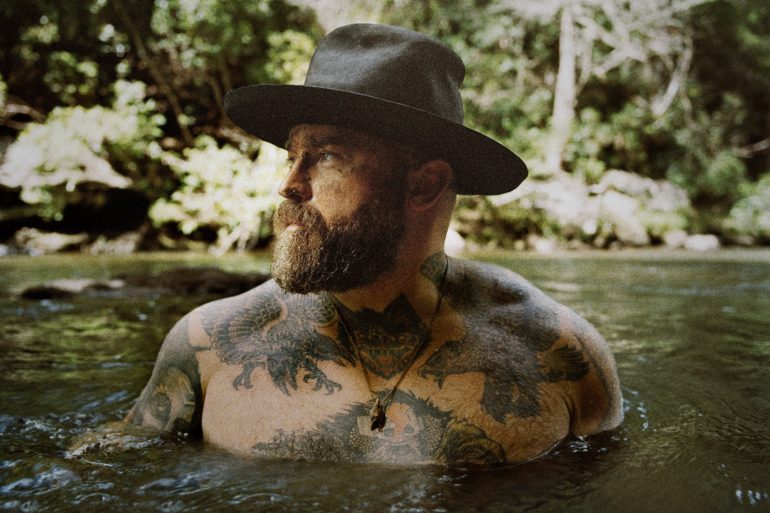 A person in a hat in a river