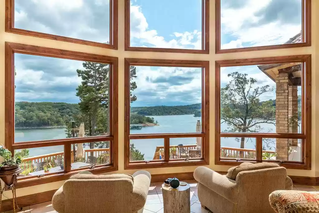 A room with a large window and a view of the water