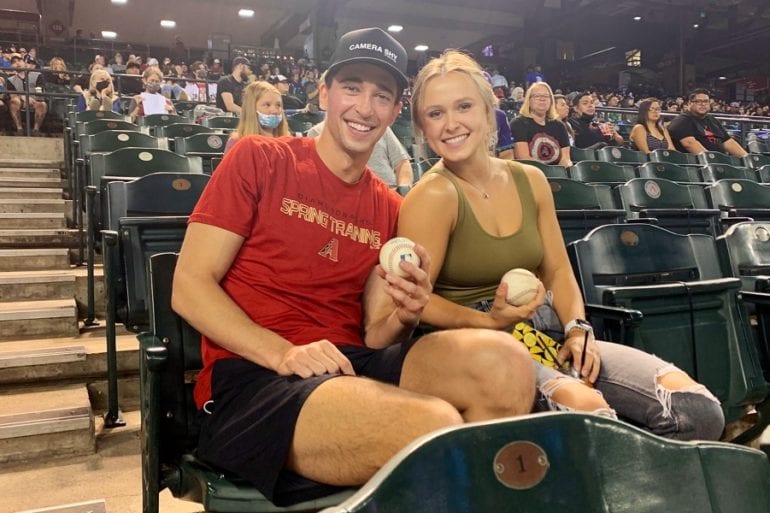 A man and woman sitting in a bleachers