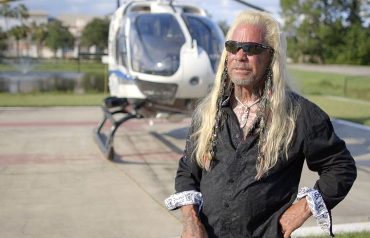 Duane 'Dog' Chapman with long hair and a beard wearing sunglasses and a black jacket