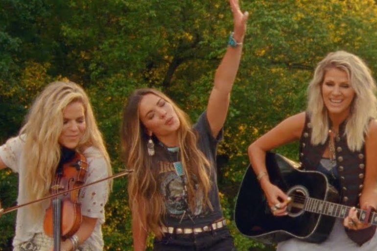 Jennifer Wayne et al. holding guitars