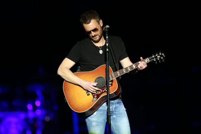 A man playing a guitar on a stage
