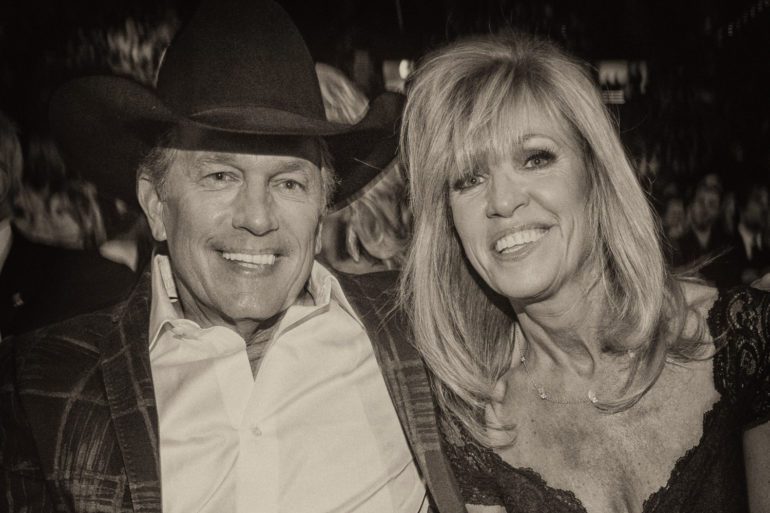 George Strait and woman posing for a picture