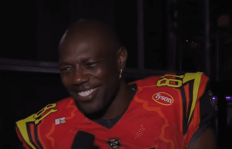 Terrell Owens wearing a red and yellow costume