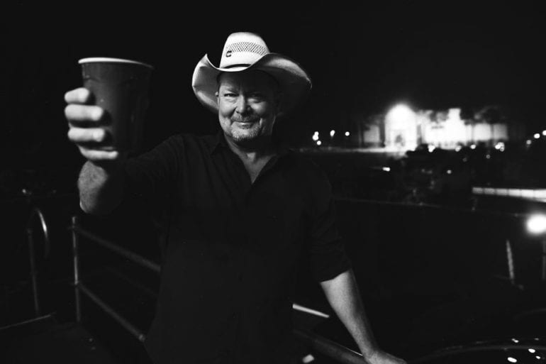 Tracy Lawrence holding a cup