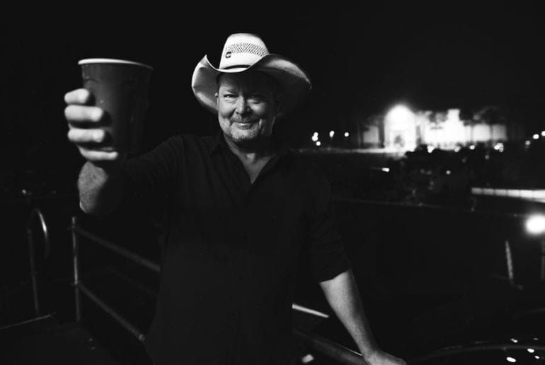 Tracy Lawrence holding a cup