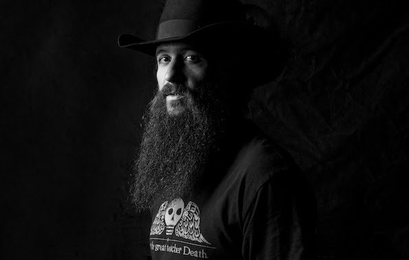 A man with a long beard and a hat